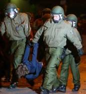 German riot police arrest a man during clashes in Berlin's Prenzlauerberg district, May 1, 2004. Fifty-eight police officers were injured in clashes with May Day demonstrators early Saturday and 111 people were detained after violence erupted in a city park, Berlin police said.  (Tobias Schwarz/Reuters)