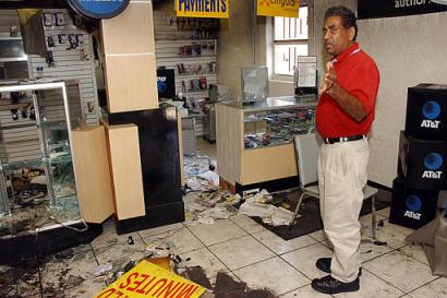 Wireless World owner Eric Mallay stands inside his looted cell phone store Thursday, May 13, 2004, in St. Petersburg, Fla. The store was damaged late Wednesday night during a riot in the same neighborhood where riots broke out after TyRon Lewis, a black motorist was was fatally shot by police in 1996. The family of Lewis is suing the city for damages in a case that went to trial this week. (AP Photo/Steve Nesius)