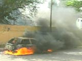 A car burned in protest of Mufti Nizamuddin Shamzai's death