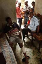 Jean-Dulsone Noncent nurses a bullet wound in the back of his calf in Petit Goave, 60 km (40 miles) southwest of  Port-au-Prince, Haiti Saturday, April 24, 2004. Noncent was wounded after an exchange of fire involving riot police and a group of civilians. (Ap Photo/Rodrigo Abd)